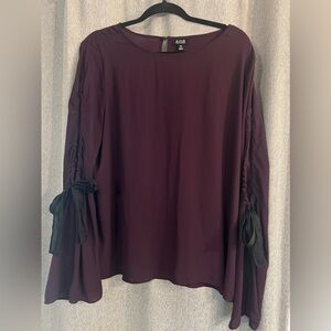 Worn once. Purple blouse with open sleeves and bows